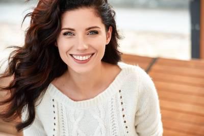 Woman smiling after a cosmetic dentistry session in Randolph,NJ