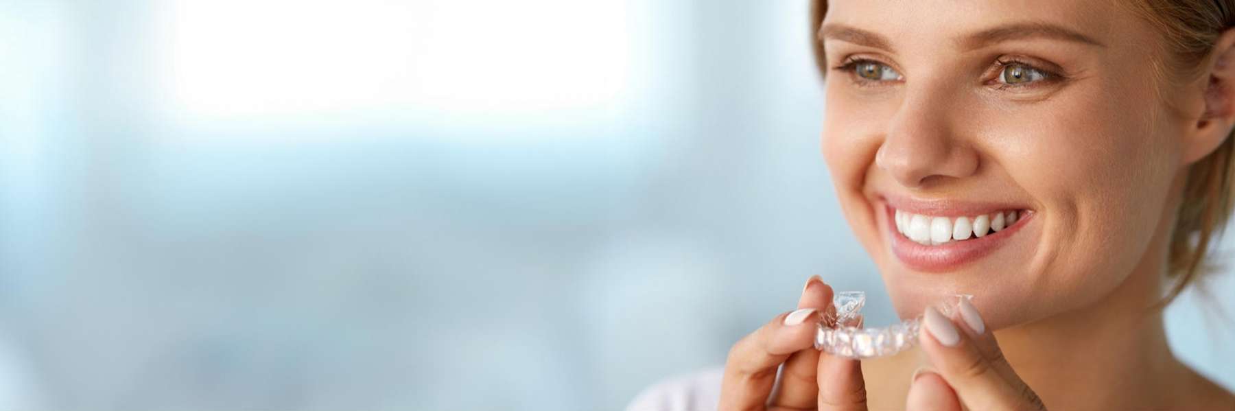 patient holding invisalign in huntsville