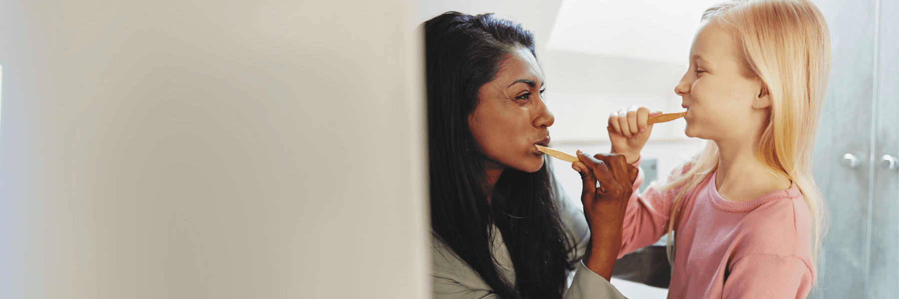 mother and daughter brushing teeth in huntsville